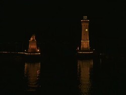 WS View of Lindau harbour entrance and lighthouse at night on Lake Constance / Lindau, Bavaria, Germany  Stock Footage