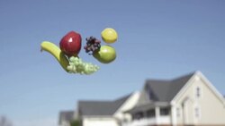 Slow Motion of Tossing Fruits Into Sky With Blurred House in The Background Stock Footage
