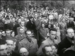 B/W 1956 PAN solemn faces of crowd gathered for funeral / Hungarian uprising Stock Footage