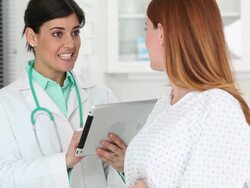 MS TU Doctor Talking to Pregnant Woman, Reviewing Electronic Medical Records / Richmond, Virginia, USA Stock Footage