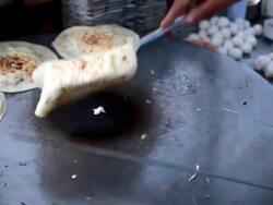 Making Parantha Roll in the Roadside restaurant Stock Footage