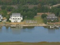 MS AERIAL Shot of wooden houses surrounded by trees at bank of river / South Carolina, United States Stock Footage