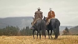 TU DS Man and woman riding horses in the mountains Stock Footage