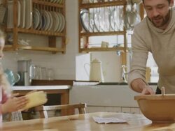 CU Shot of Daddy & daughter in kitchen discuss recipe, girl jumping with excitement / London, United Kingdom  Stock Footage
