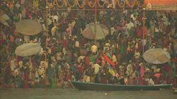Bathers wash in the Ganges as hundreds wait their turn and others ride in boats. Stock Footage