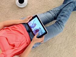 WS ZI Woman watching footage on digital tablet / London, London, United Kingdom Stock Footage