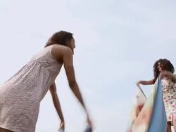 MS Two young girl laying out blanket for picnic inside park near urban area / Minneapolis, Minnesota, United States Stock Footage
