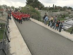  MS Red band walking across bridge on easter parade AUDIO / Kerkyra, Corfu, Greece Stock Footage