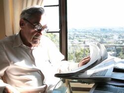 Senior looks at stock page Stock Footage