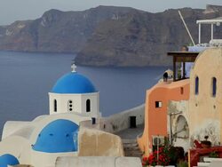 Blue Domed white washed churches of Oia overlooking the Aegean Sea on the Island of Santorini, Greece, Europe Stock Footage