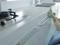 MS PAN Young woman cleaning kitchen counter cabinets / China Stock Footage