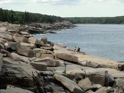 WS Two people sitting on rock at bank of river/ Acadia National Park, Vermont, United States Stock Footage