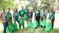 Portrait of smiling environmentalist volunteers picking up trash Stock Footage