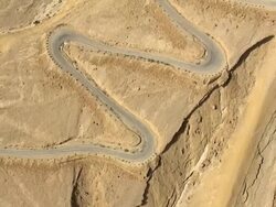 Aerial winding road in desert, Negev, Israel Stock Footage