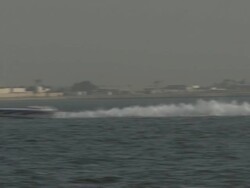 MS POV Toss speed boats race through water / Doha, Qatar   Stock Footage