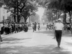 B/W 1963 Black protesters running across street at civil rights demonstration / police in foreground / AL Stock Footage
