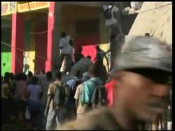 More than a week after the earthquake devastated Haiti''s capital, people continue to openly loot shops. Throngs of people climbed into shattered buildings and tossed goods to friends, or carried sacks away. News Clip