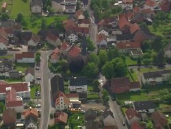 MS AERIAL ZO Shot of church and houses along with railway tracks at Obersuhl / Germany Stock Footage