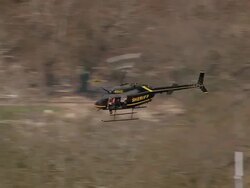 Aerial Sherriff's Bell 206 JetRanger helicopter flying over beach and residential area / Mississippi Stock Footage