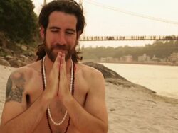 Portrait of a sage doing namaste at ganges riverbank, Laxman Jhula, Rishikesh, Uttarakhand, India Stock Footage