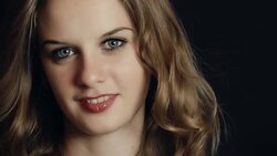 Young and beautiful blonde with blue eyes looking at camera Stock Footage