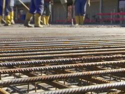 Workers Directing Concrete Onto The Construction Site Stock Footage