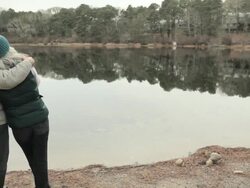 Loving mature couple by lake Stock Footage