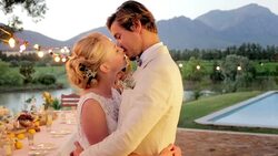 Bride and groom hugging and kissing at wedding reception Stock Footage