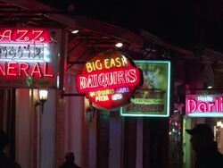 Nightlife neon signs on Bourbon Street at Jazz Funeral in New Orleans Stock Footage