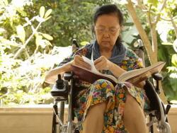 Asian adult woman sitting on her wheelchair Stock Footage