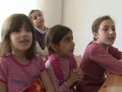 Children sing in Syrian Civil War refugee camp make-shift classroom Stock Footage
