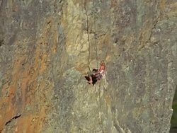 Aerial around female mountain climber descending Stock Footage