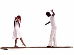 Young Couple Playing Equilibrium on a Rope Stock Footage