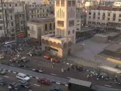 High Angle, pan-right tilt-up - Traffic drives through an Egyptian city Stock Footage