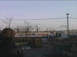 New Orleans: Streetcar / Tram Passes Ship on Mississippi River Stock Footage