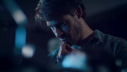 Man in motorcycle workshop looking at his bike Stock Footage