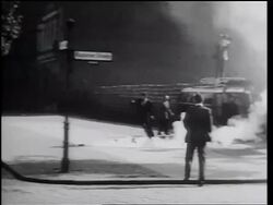 B/W 1961 smoke bomb being thrown over Berlin Wall / man picks it up + throws it back / Germany Stock Footage