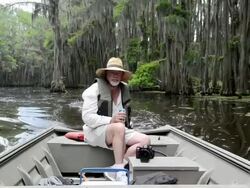 MS Shot of man driving boat though swamp / United States Stock Footage