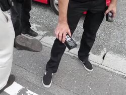 Safecast volunteers test shoes for radioactivity level Stock Footage