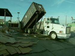 Cardboard and trucks at recycling center Stock Footage