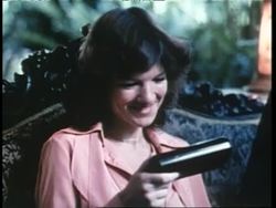 A woman uses a hand held electronic dictionary and two boys use a VCR. News Clip