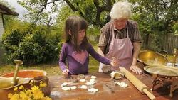 Cooking With Grandma-Beautiful Little Girl Learns How To Make Cookies  in The Bright-lit Vintage Kitchen Stock Footage