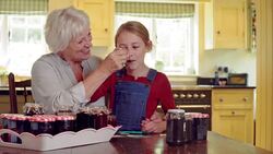 Grandmother and granddaughter tasting fresh homemade jam Stock Footage