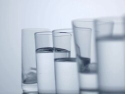 Glasses filled with water, slow motion Stock Footage
