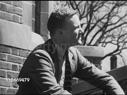 1951: HARVARD UNIVERSITY STUDENTS: VS Male students talking, socializing, walking by dormitories at edge of Yard, two friends into building together, stopping in hall to look at Alumni list 'Allen, Andrews, Adams, Cabot...Holmes...', continue walking Instructional Video