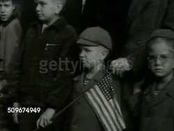 1942: U.S. NAVY & ARMY PARADE: HA WS US Sailors marching in parade. MS Children watching, one holding US flag. HA WS Army soldiers marching in formation down street. World War II, WWII Instructional Video