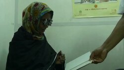 An elderly woman has an eye examination and test by an optician before being given new glasses by a healthcare NGO in rural Bangladesh operating from a hospital ship Stock Footage