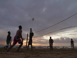 MS Silhouettes of men playing beach volleyball at sunset / Hikkaduwa, Southern Province, Sri Lanka Stock Footage