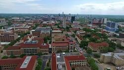 flying away Orange Rooftops Campus UT Tower Aerial Fly by Austin Texas Over University of Texas at Austin Capital Cities with Downtown Cityscape Skyline in the background at Center moving forwards close with Pool and Amazing Architecture and Church Stock Footage