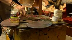 Paint being mixed on a palette News Clip